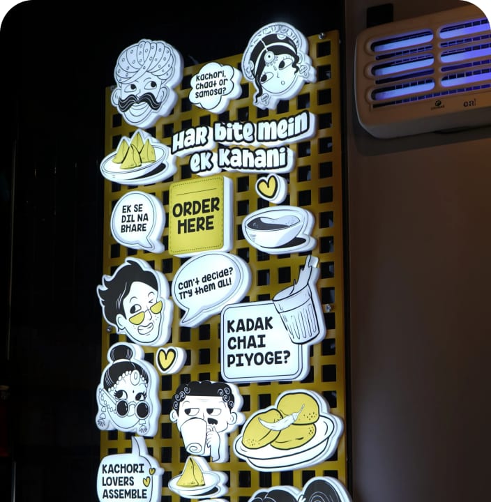 The Kachori Story interior wall with playful die-cut stickers and speech bubbles